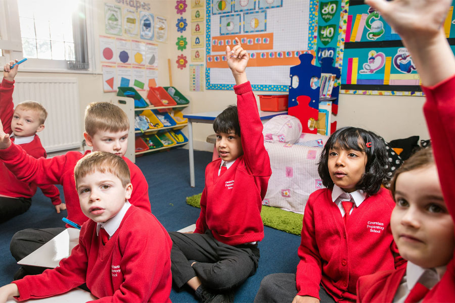 Infant pupils learning in a classroom